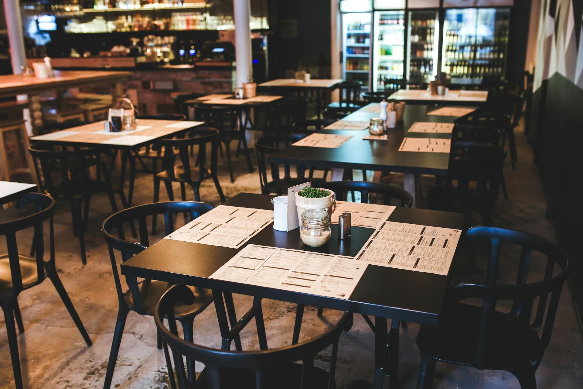 Restaurant interior with tables, chairs, and a bar area